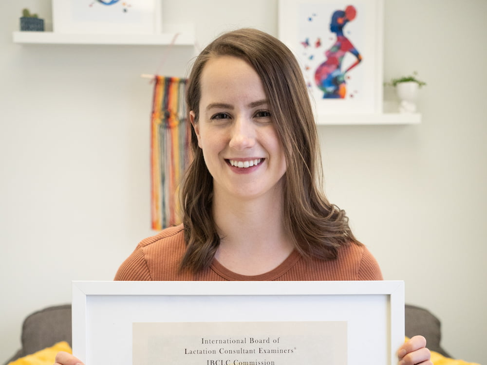 Michelle holding her IBCLC certification